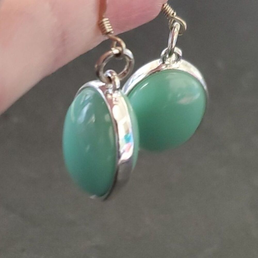 Silver tone greenish dangling earrings